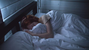 woman-sleeping-in-bed-dark-relaxation-santa-cruz