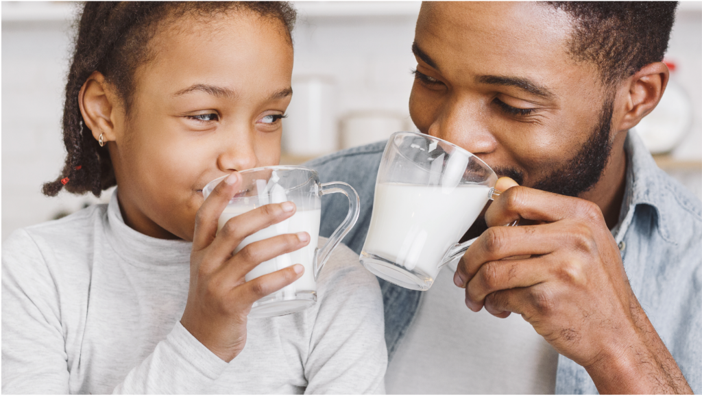 Parent and child drinking milk alternative together