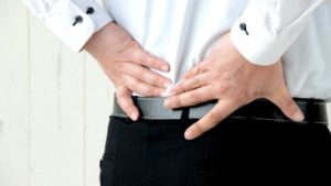 Office worker suffering from lower back pain