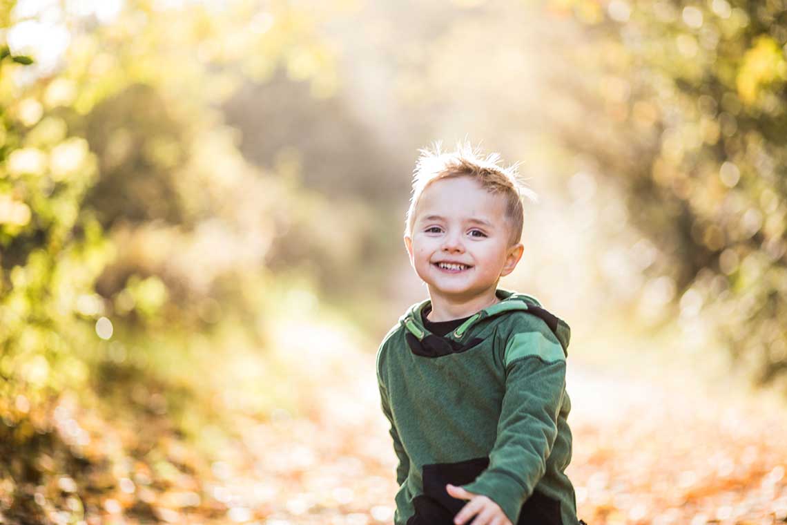 happy kid running on the woods